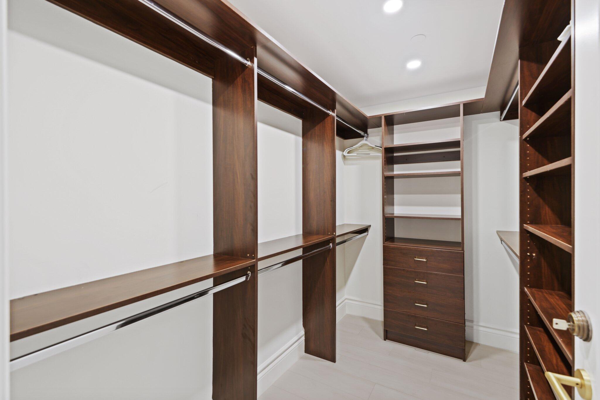 200 East Palmetto Park Road, Unit 811 Boca Raton, FL 33432 - Photo 28 of 44 a view of walk in closet with clothes and shoes