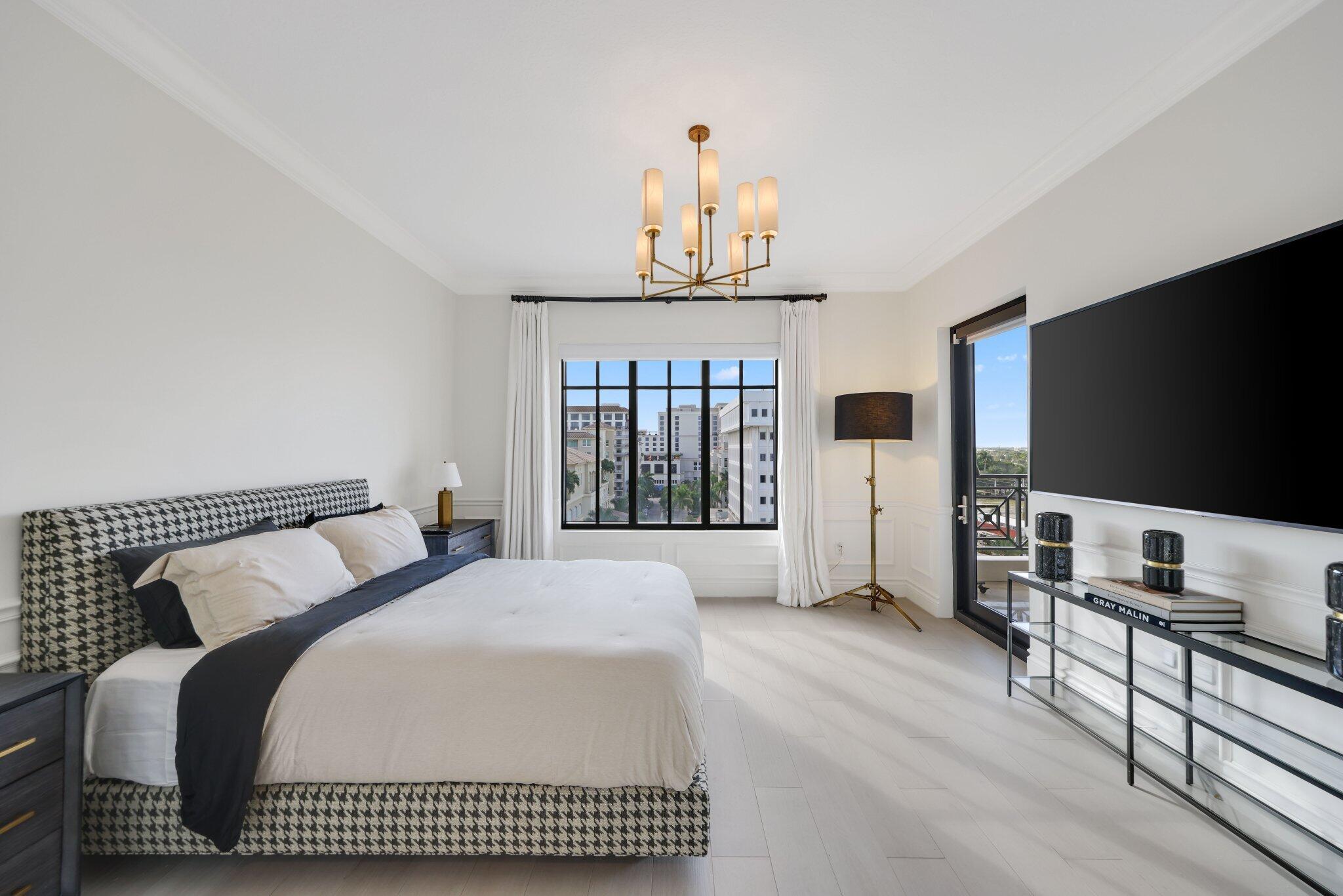 200 East Palmetto Park Road, Unit 811 Boca Raton, FL 33432 - Photo 29 of 44 a bedroom with a bed and a flat screen tv