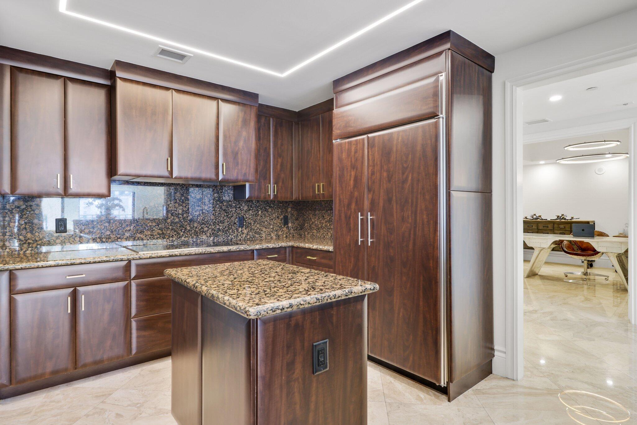 200 East Palmetto Park Road, Unit 811 Boca Raton, FL 33432 - Photo 9 of 44 a kitchen with a sink refrigerator and cabinets