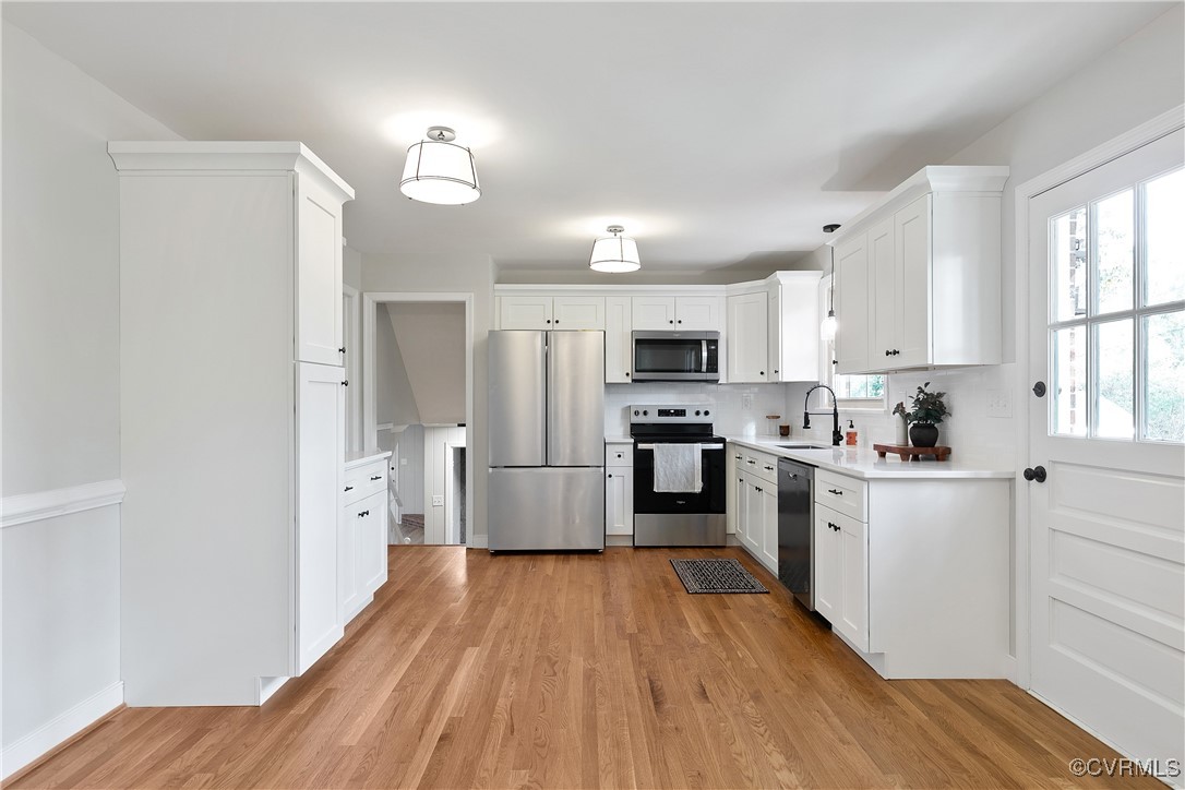 9761 Tuxford Road Chesterfield, VA 23236 - Photo 12 of 49 Kitchen featuring decorative backsplash, light har