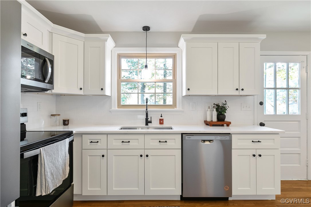 9761 Tuxford Road Chesterfield, VA 23236 - Photo 19 of 49 Kitchen with white cabinets, wood-type flooring, s