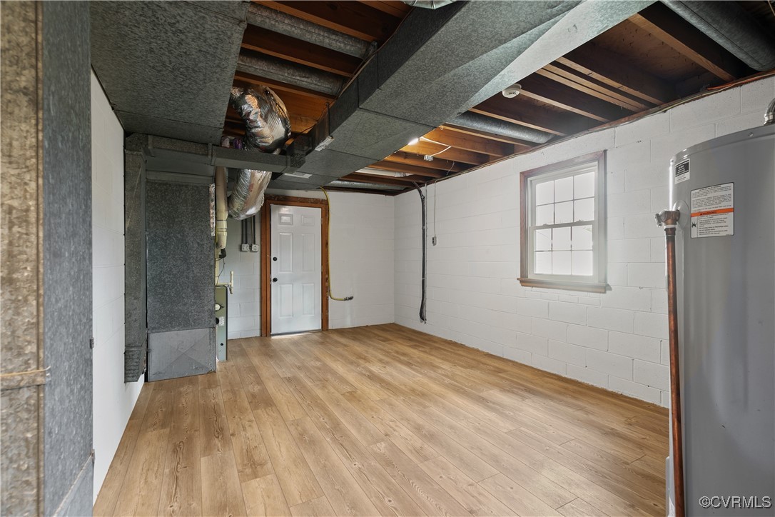 9761 Tuxford Road Chesterfield, VA 23236 - Photo 25 of 49 Basement featuring water heater, hardwood / wood-s