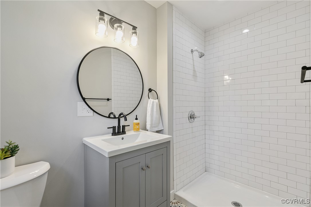 9761 Tuxford Road Chesterfield, VA 23236 - Photo 30 of 49 Bathroom featuring vanity, a tile shower, and toil