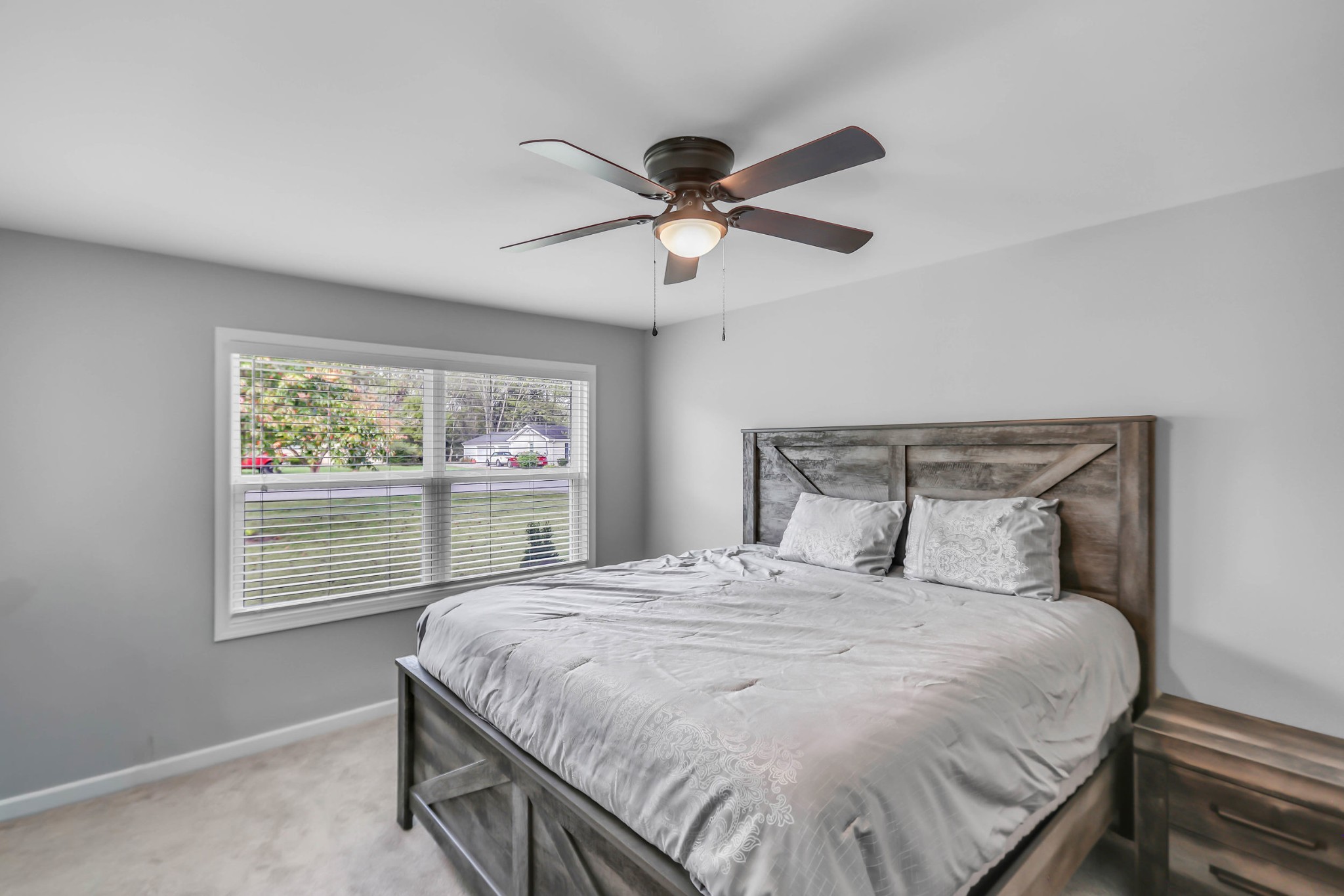 105 Jerry Street Portland, TN 37148 - Photo 14 of 40 a bedroom with a large bed and a chandelier fan