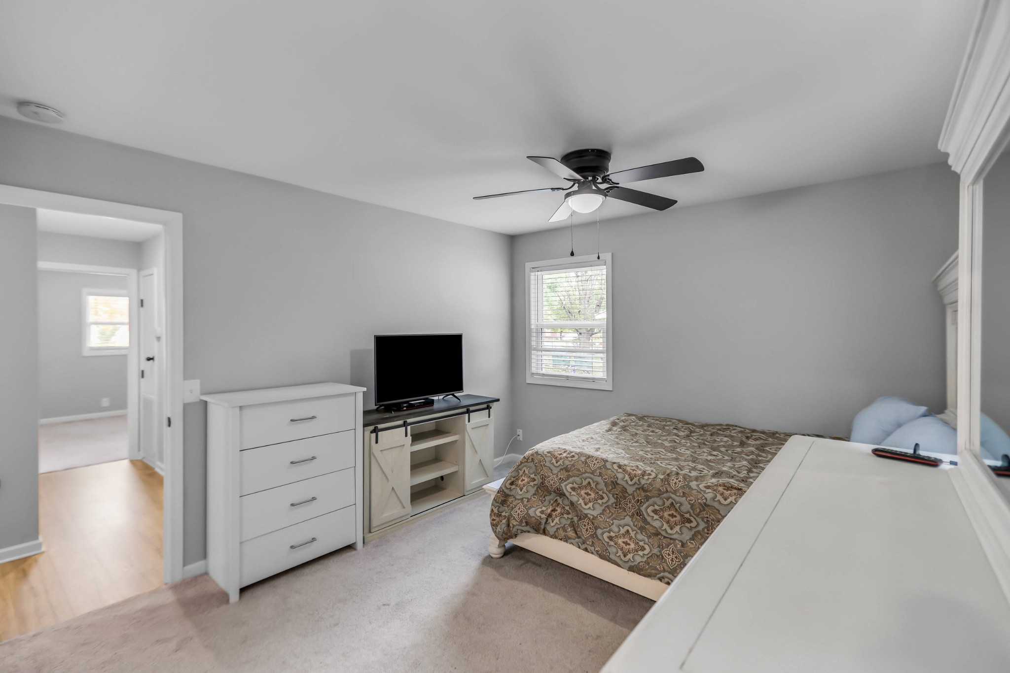 105 Jerry Street Portland, TN 37148 - Photo 16 of 40 a bedroom with a bed and a flat tv screen on dresser