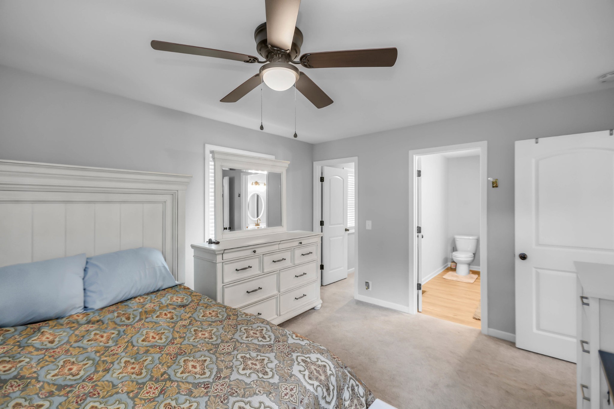 105 Jerry Street Portland, TN 37148 - Photo 17 of 40 a bedroom with a bed and a chandelier