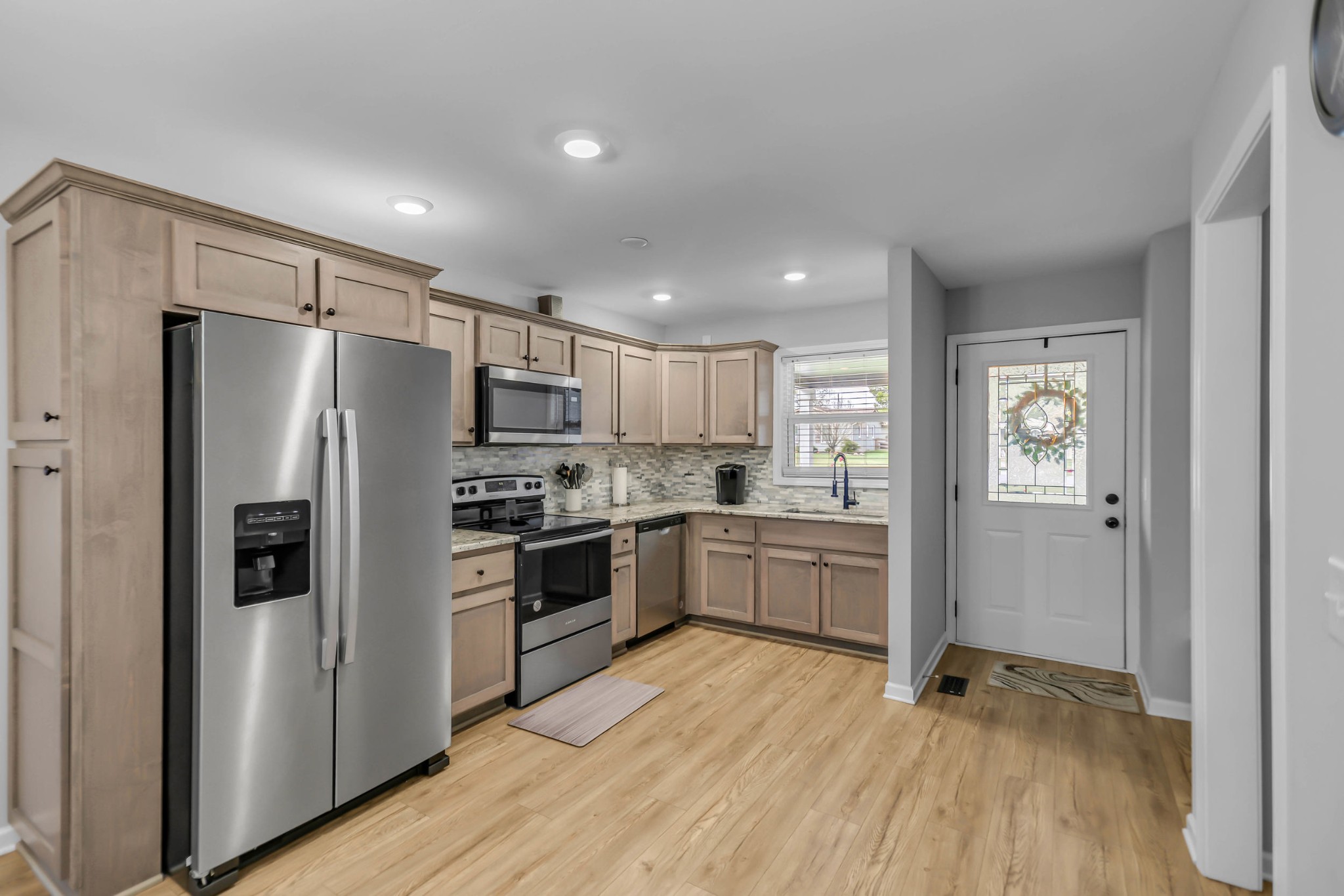 105 Jerry Street Portland, TN 37148 - Photo 5 of 40 a kitchen with a refrigerator and a stove top oven