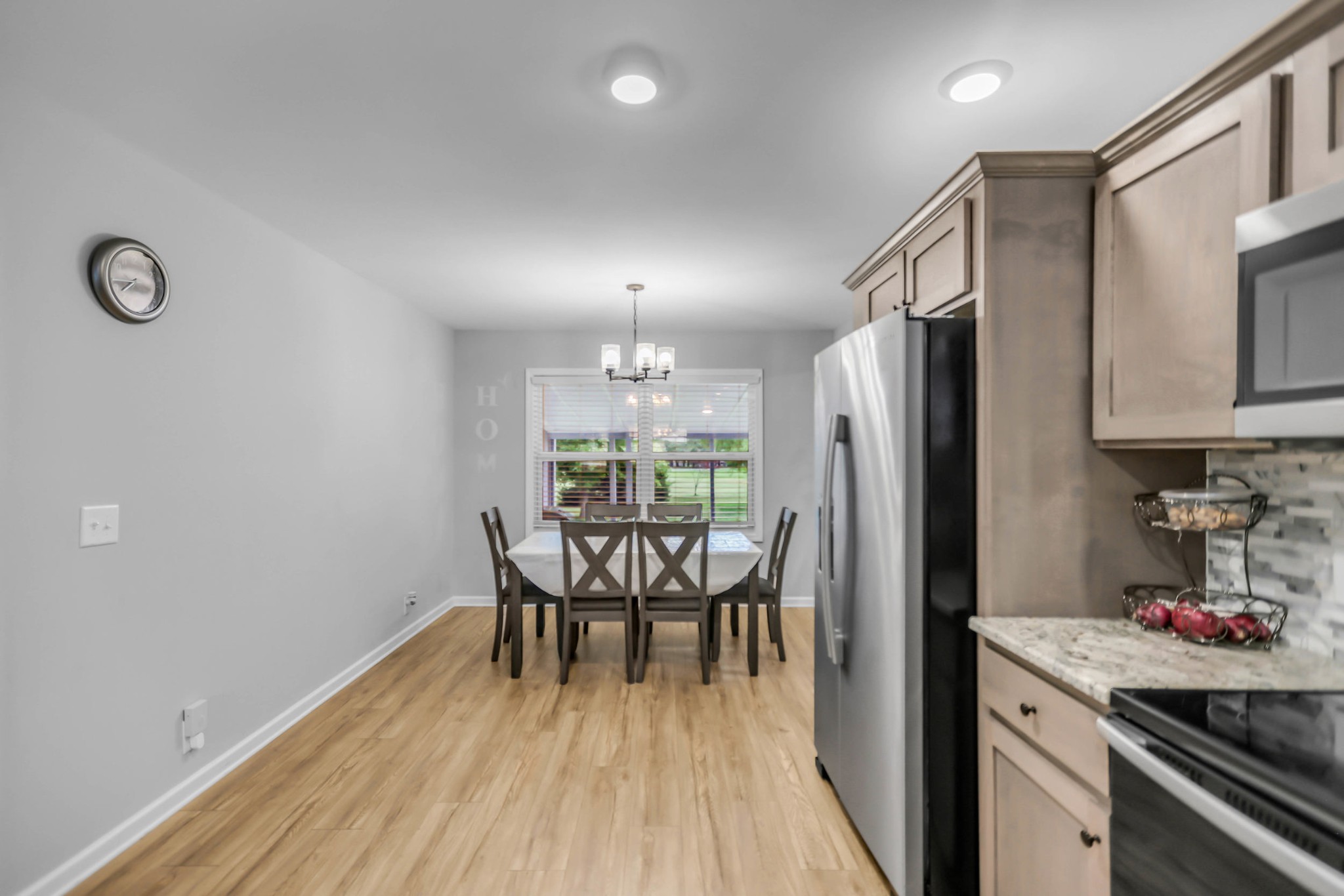 105 Jerry Street Portland, TN 37148 - Photo 9 of 40 a kitchen with a table chairs refrigerator and cabinets