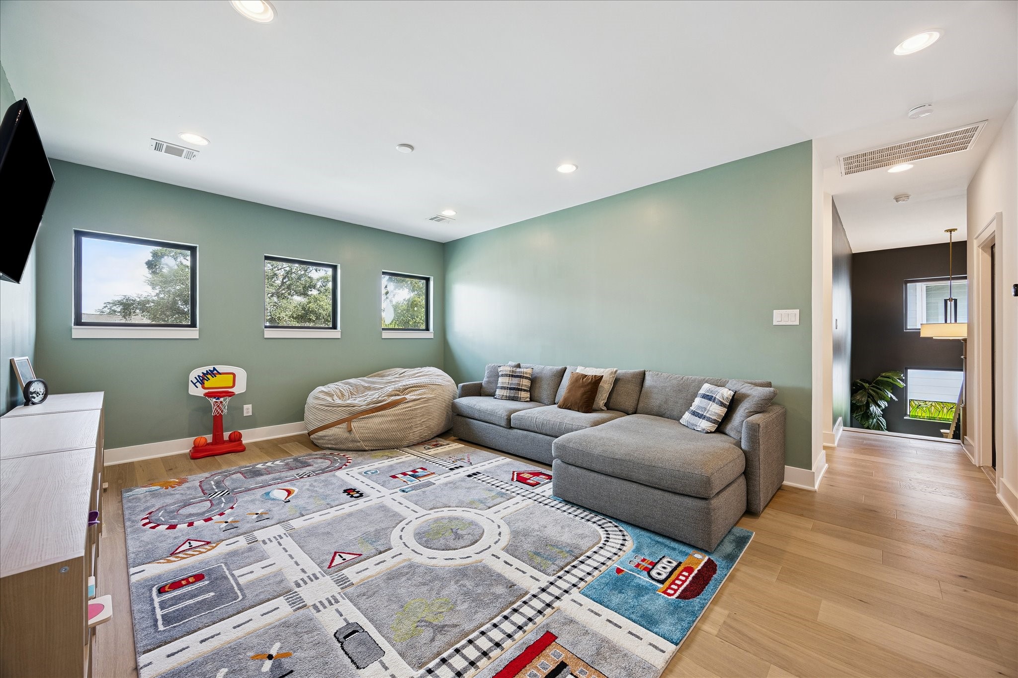 1313 Thornton Road Houston, TX 77018 - Photo 21 of 32 The expansive game room provides the perfect space for movie nights, gaming, or a children's play area, offering endless flexibility for today's lifestyle.