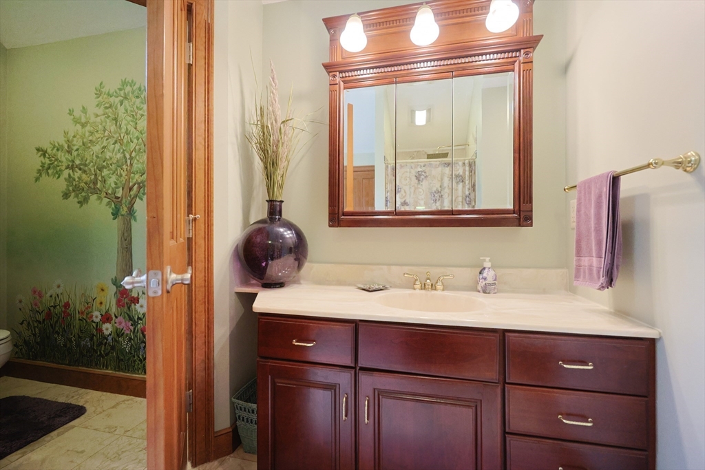 70 Azalea Way Hanson, MA 02341 - Photo 29 of 42 a bathroom with a sink and a mirror