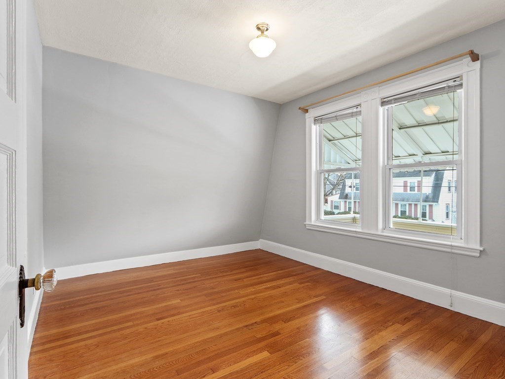 169 George Street Medford, MA 02155 - Photo 13 of 22 an empty room with wooden floor and windows