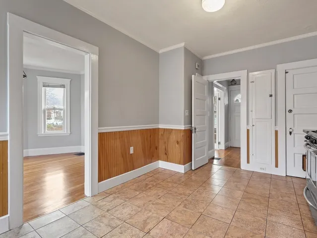 a view of a hallway with wooden shelves