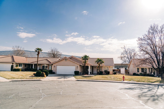 1825 West Mathis Park Place, Unit 40 St. George, UT 84770 - Photo 2 of 28 View of front facade with a tile roof, concrete driveway, a residential view, and stucco siding