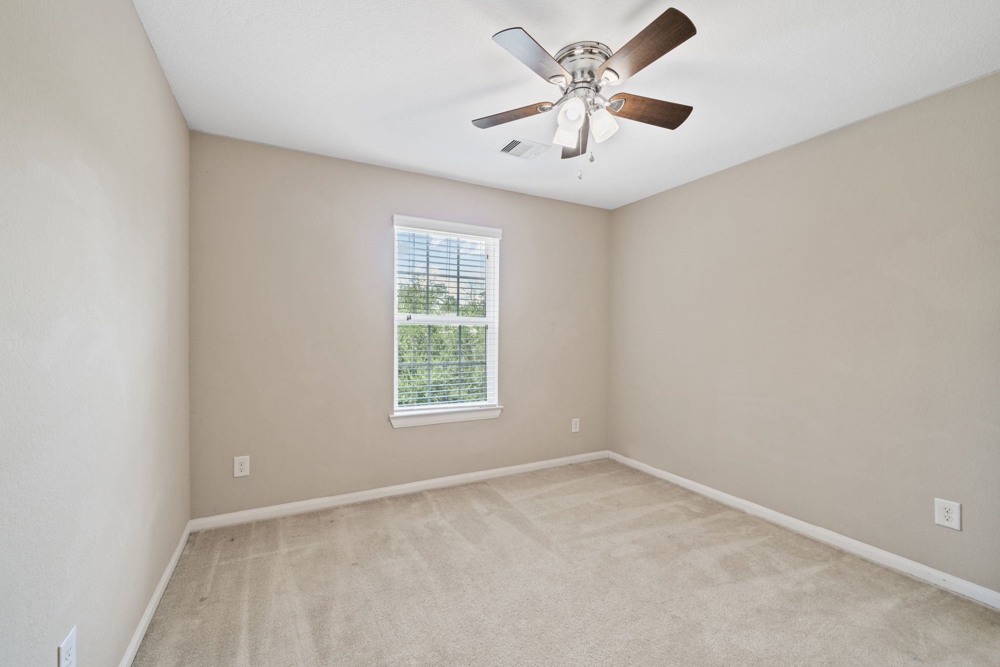 22523 Birch Ridge Meadow Drive Spring, TX 77389 - Photo 27 of 39 an empty room with a window and a fan
