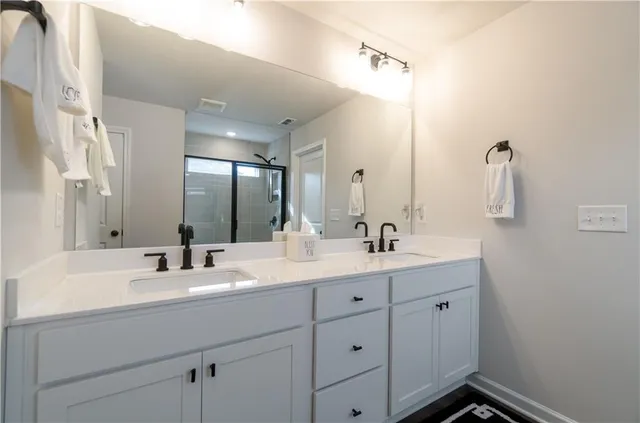 a bathroom with a double vanity sink and mirror