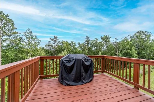 a balcony with wooden floor and fence
