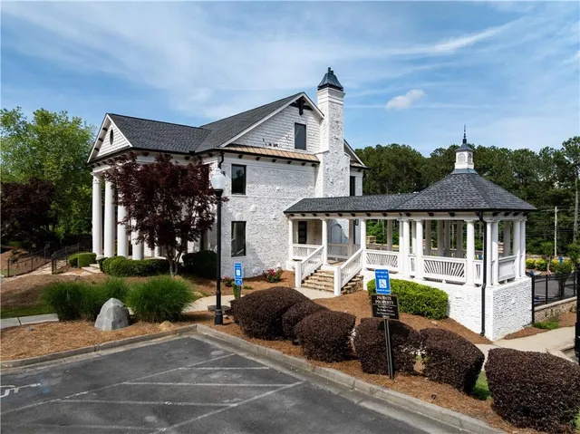 an aerial view of a wooden house with a yard and potted plants