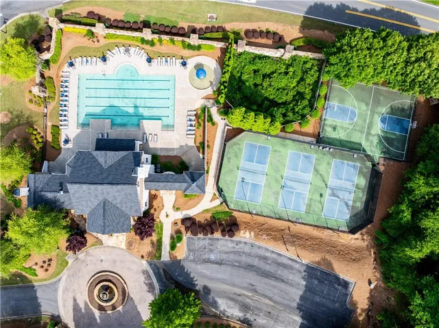 an aerial view of a house with swimming pool garden and patio