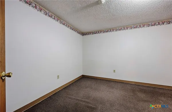 an empty room with a wooden floor and a window