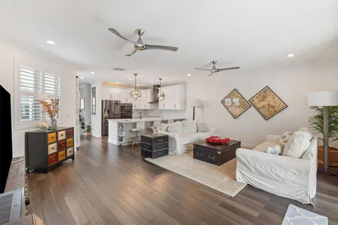 a living room with furniture and kitchen view