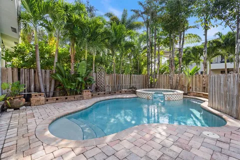 a view of a swimming pool with sitting area and furniture