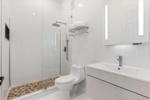 a bathroom with a toilet a sink and shower
