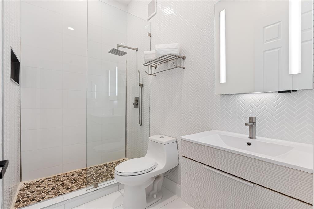 518 Southwest 9th Street, Unit 518 Fort Lauderdale, FL 33315 - Photo 9 of 29 a bathroom with a toilet a sink and shower