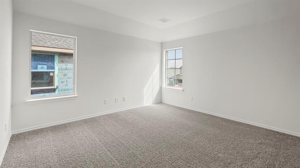 216 Pheasant Run Road Terrell, TX 75160 - Photo 26 of 37 Recessed ceiling detail, two windows with white trim, wall-to-wall carpeting, and neutral paint