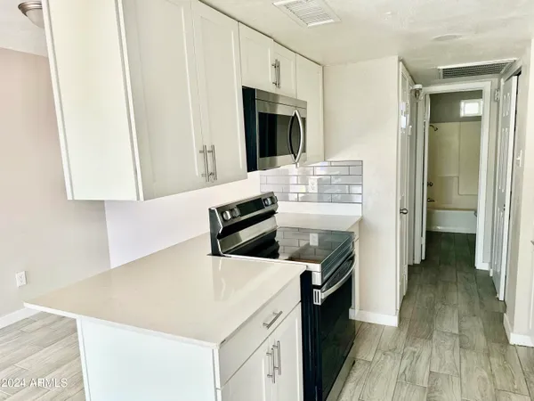 a kitchen with a stove and a refrigerator