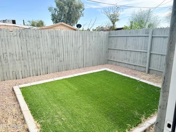 a view of a backyard with a wooden fence