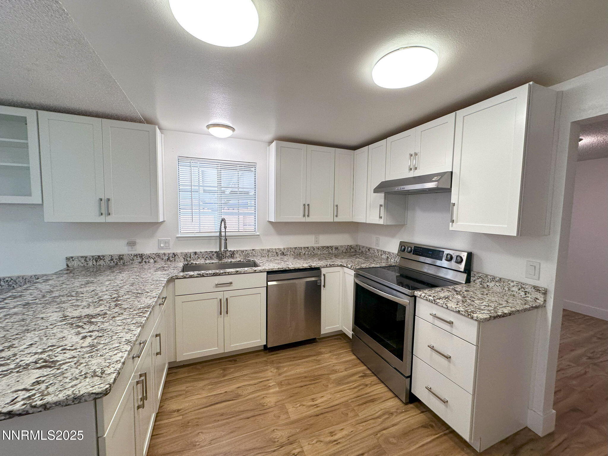 3095 Randolph Drive Reno, NV 89502 - Photo 4 of 20 a kitchen with stainless steel appliances granite countertop a stove sink and cabinets