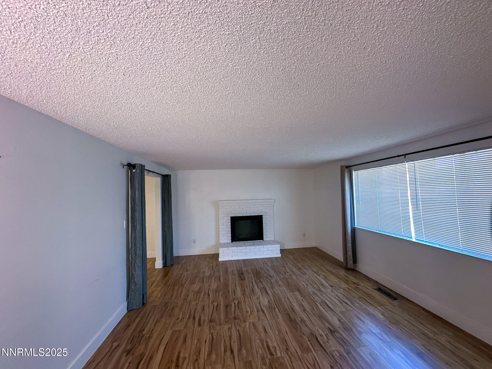 3095 Randolph Drive Reno, NV 89502 - Photo 5 of 20 wooden floor in an empty room with a window