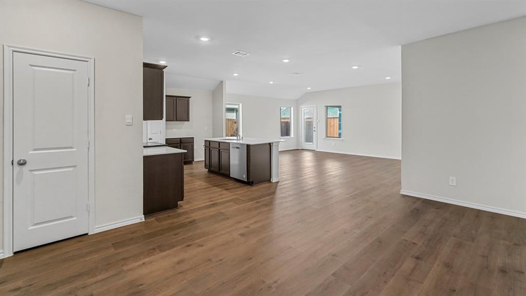 1953 Freeman Street Tyler, TX 75704 - Photo 11 of 32 Spacious open-concept living area featuring wood-finish flooring, recessed lighting, and a kitchen island with built-in cabinetry and an integrated dishwasher