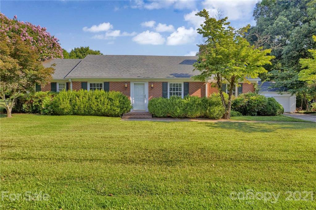 a front view of house with yard and green space