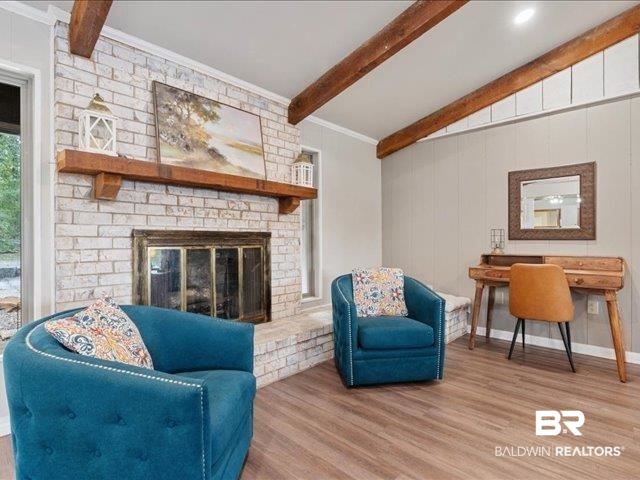4650 Wiggins Lane Wilmer, AL 36587 - Photo 7 of 66 Living area with wood finished floors, a brick fireplace, and crown molding