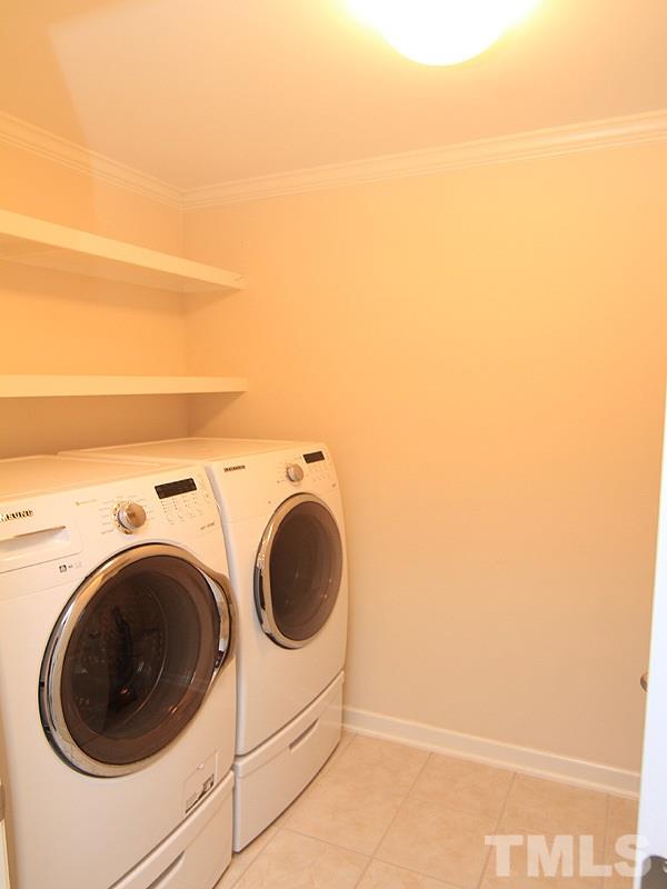 3524 Edgemont Drive Raleigh, NC 27612 - Photo 11 of 17 Laundry room with shelving...the washer/dryer conveys with the property.