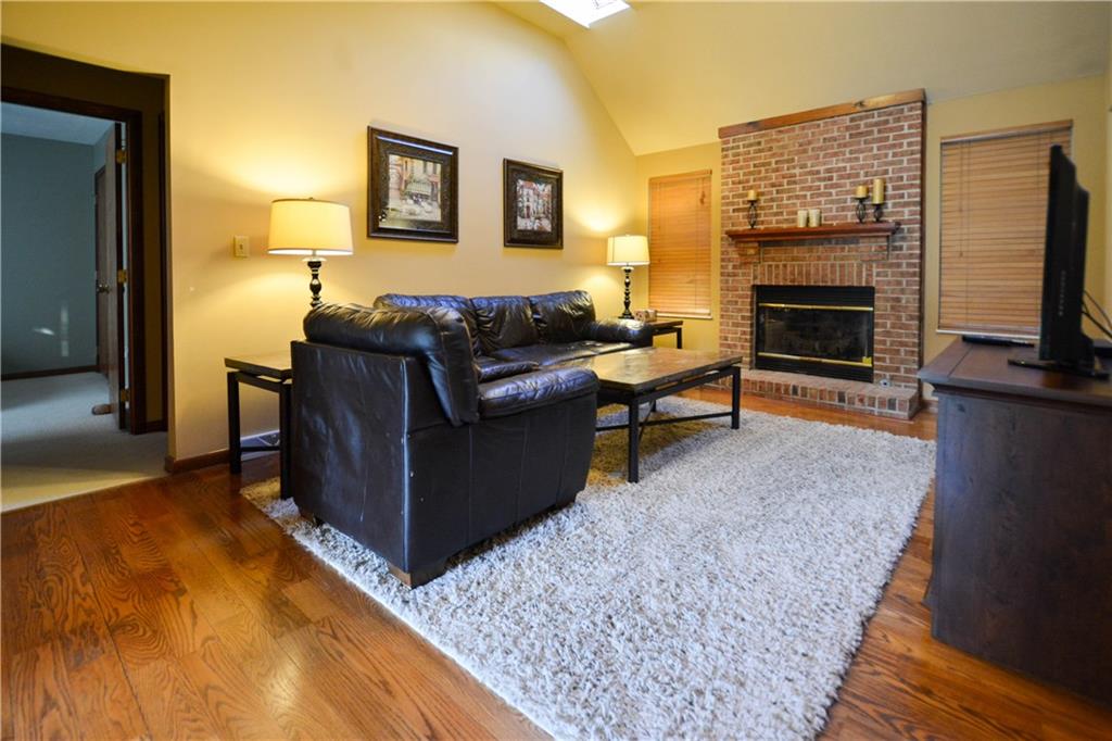 GREAT ROOM WITH HARDWOOD FLOORS AND BRICK HEARTH