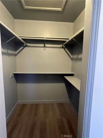 a hallway with sliding door and wooden cabinet