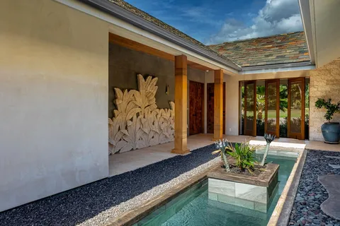 a kitchen with a stove and a white wooden cabinets