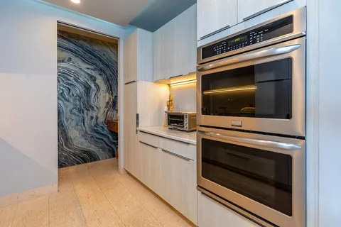 an aerial view of a house with swimming pool and lake view