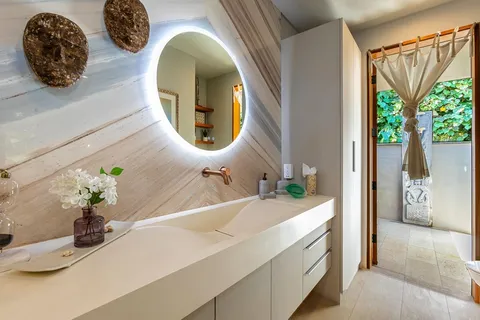 a view of a table and chairs under an umbrella in front of house