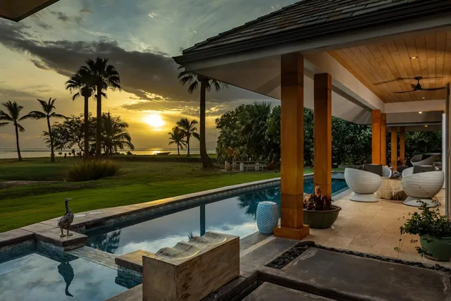 a living room with fireplace furniture and a large window