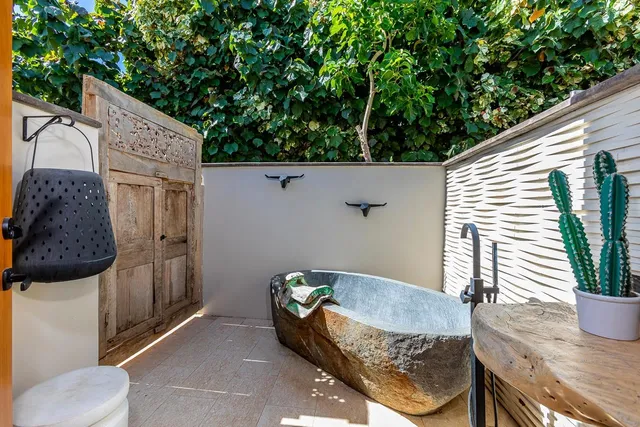 a view of a backyard with plants and patio