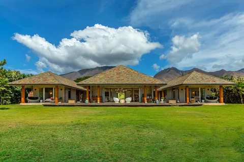 a backyard of a house with table and chairs
