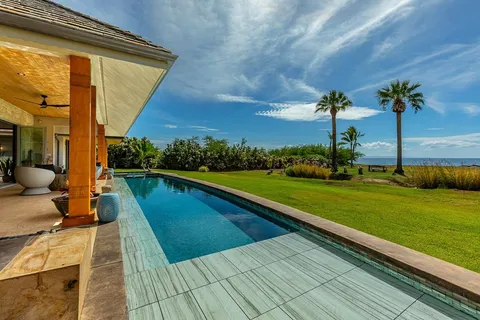a bathroom with a tub sink and mirror