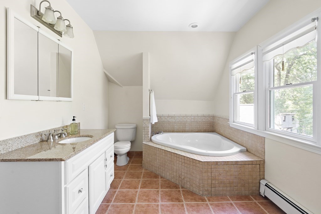 26 Leland Road Brookline, MA 02467 - Photo 12 of 30 a bathroom with a sink a toilet a window and vanity