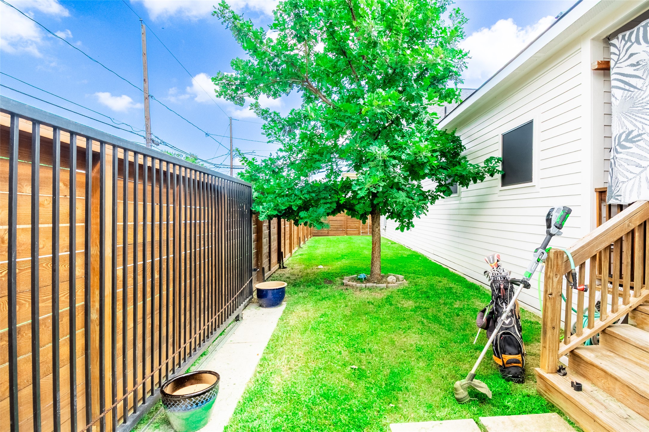 200 Carl Street Houston, TX 77009 - Photo 5 of 32 a view of backyard with plants and wooden fence