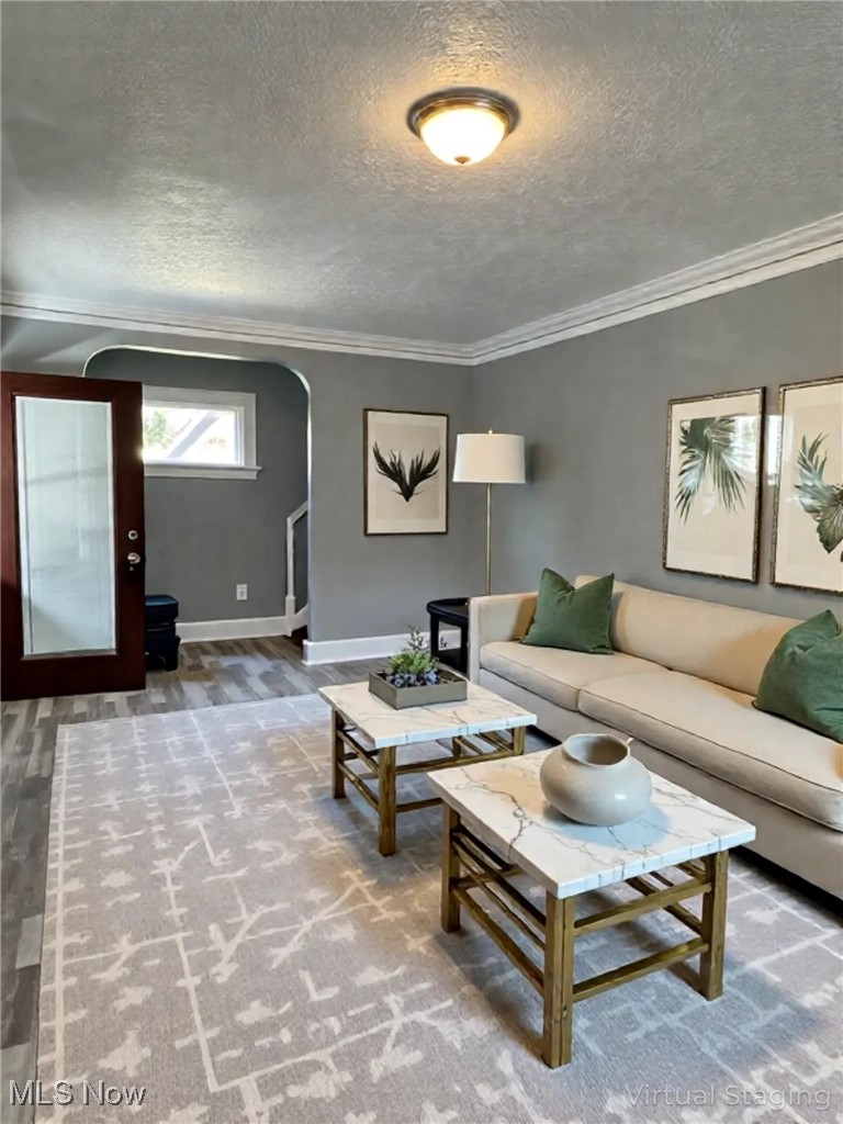 2121 Alton Road Cleveland, OH 44112 - Photo 2 of 44 Living area with arched walkways, a textured ceiling, and ornamental molding