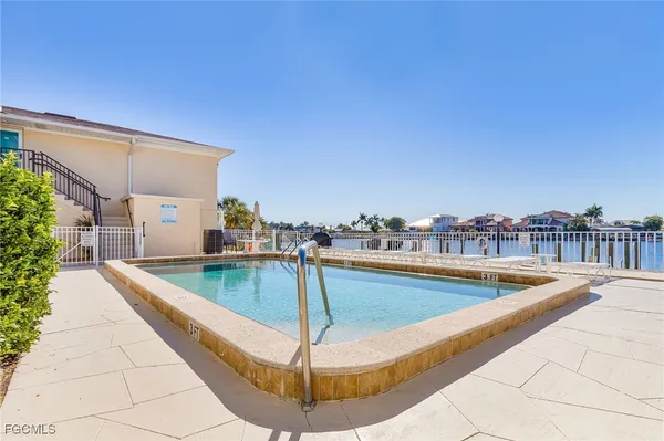 a view of a swimming pool with a lounge chair