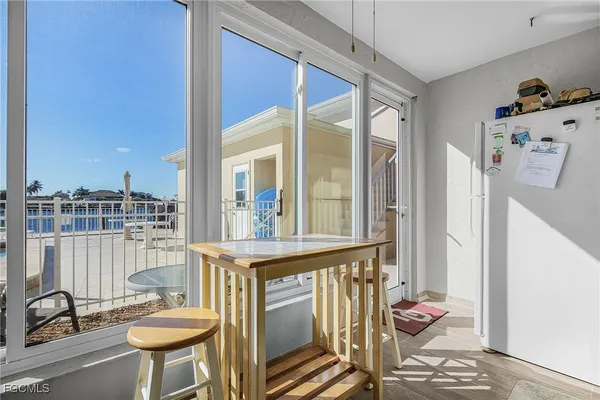 a view of a dining room with furniture and a window